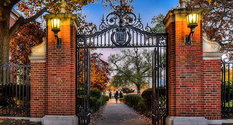 image of howard university gates on campus leading to walkway